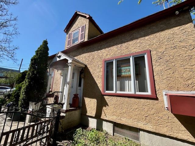 43-51 166th St, Flushing, NY 11358 - view of side of property featuring stucco siding