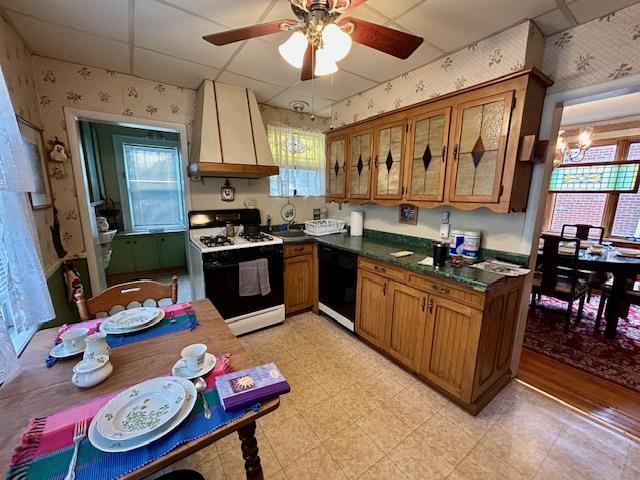 43-51 166th St, Flushing, NY 11358 - kitchen featuring dishwasher, wallpapered walls, a healthy amount of sunlight, custom range hood, and gas range oven