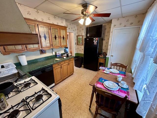 43-51 166th St, Flushing, NY 11358 - kitchen with a ceiling fan, dark countertops, black appliances, light floors, and wallpapered walls