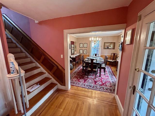43-51 166th St, Flushing, NY 11358 - dining space featuring light wood-type flooring, stairs, and a notable chandelier