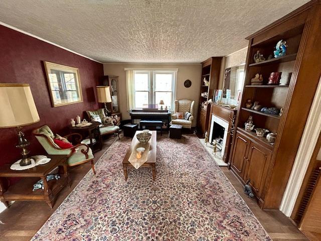 43-51 166th St, Flushing, NY 11358 - living area with ornamental molding, a textured ceiling, and a fireplace