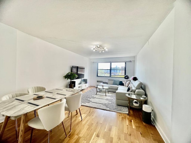 39-60 54th St Unit 7U, Woodside, NY 11377 - dining room featuring baseboards and light wood-style floors