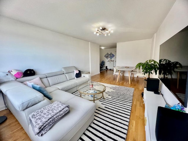 39-60 54th St Unit 7U, Woodside, NY 11377 - living area featuring light wood finished floors and a textured ceiling