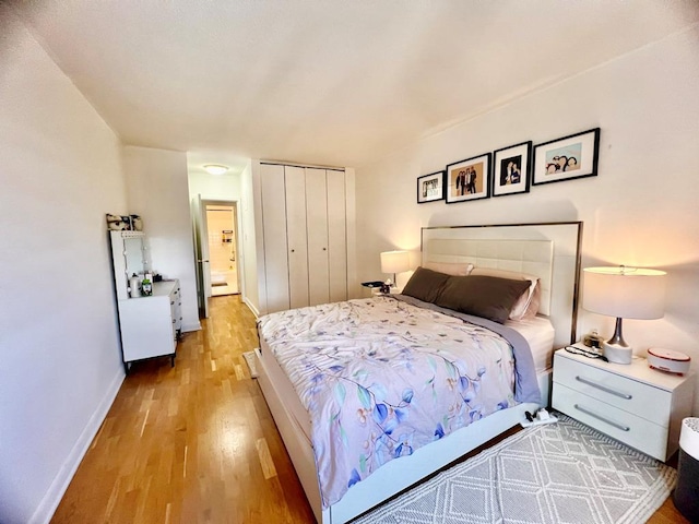39-60 54th St Unit 7U, Woodside, NY 11377 - bedroom featuring light wood finished floors, a closet, and baseboards