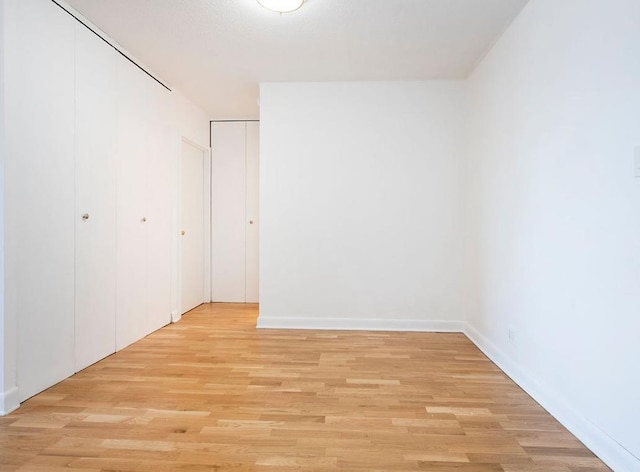 39-60 54th St Unit 7U, Woodside, NY 11377 - unfurnished bedroom featuring baseboards and light wood-type flooring
