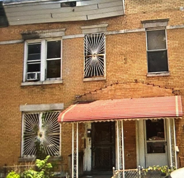 property entrance featuring brick siding