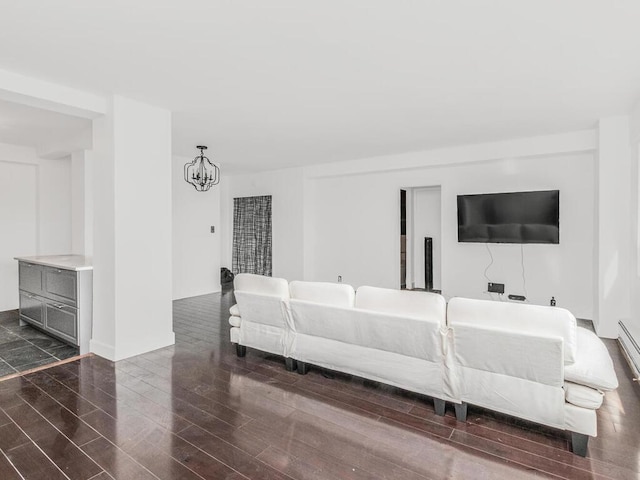living room featuring dark wood-type flooring and a chandelier