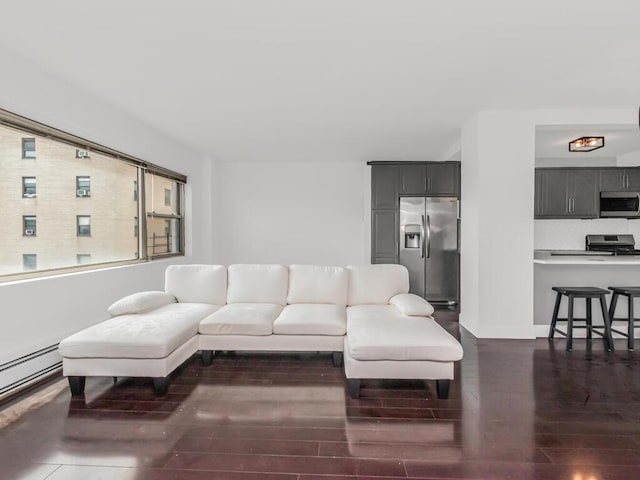 living area featuring baseboards and dark wood-style floors