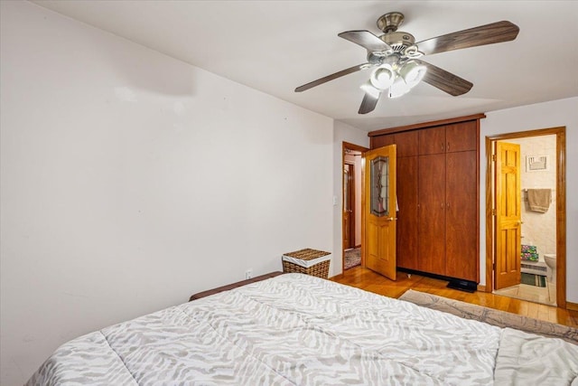 bedroom featuring a ceiling fan, a closet, and light wood-style flooring