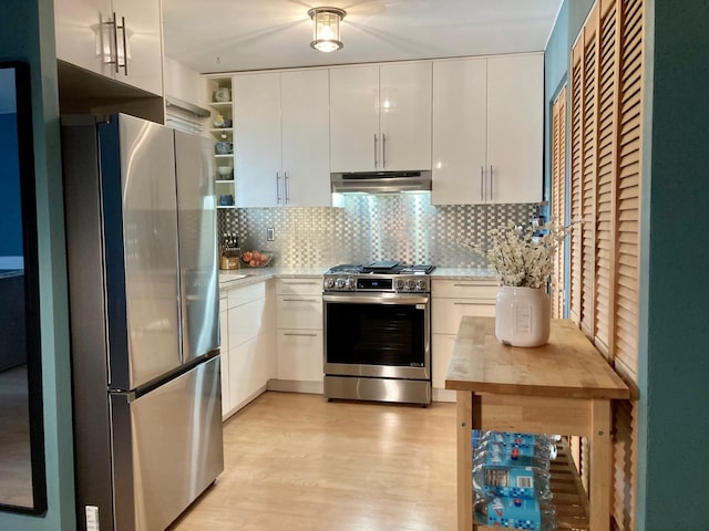 kitchen featuring light countertops, backsplash, stainless steel appliances, and under cabinet range hood