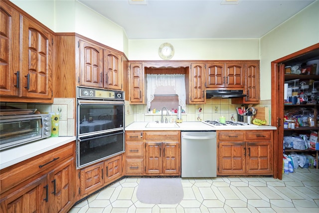 1464 W 5th St, Brooklyn, NY 11204 - kitchen featuring stainless steel dishwasher, a sink, under cabinet range hood, tasteful backsplash, and light countertops