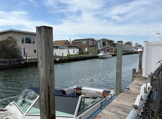 dock area with a water view and a residential view