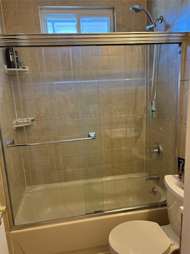 full bathroom featuring enclosed tub / shower combo and toilet