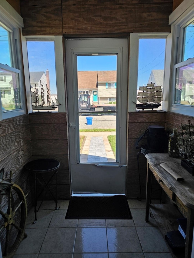 doorway with dark tile patterned flooring