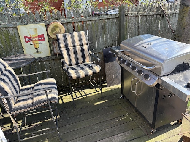 deck with fence and a grill