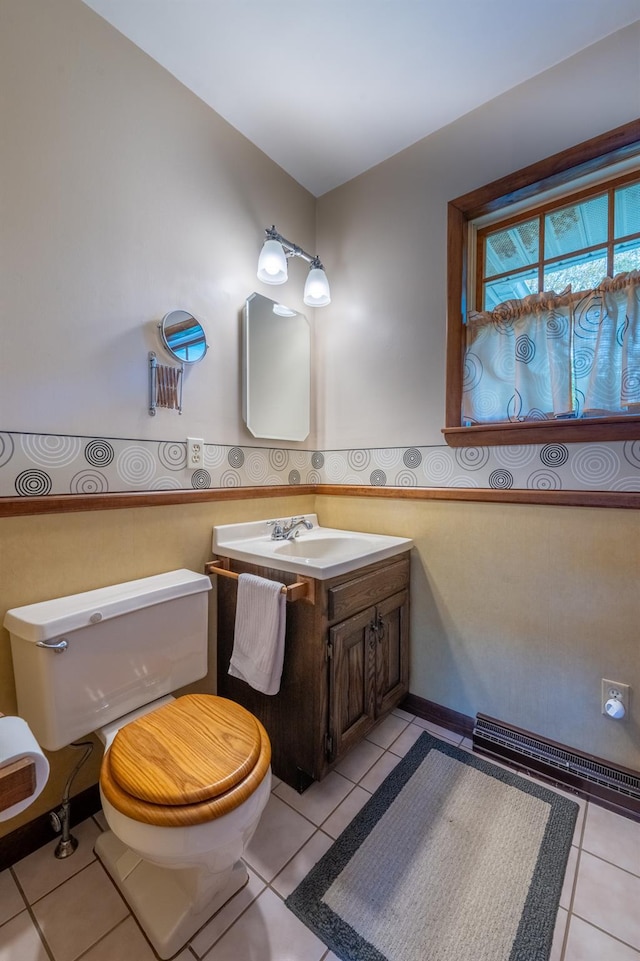 11 Mcintosh Dr, Poughkeepsie, NY 12603 - half bathroom featuring toilet, wainscoting, tile patterned flooring, and vanity