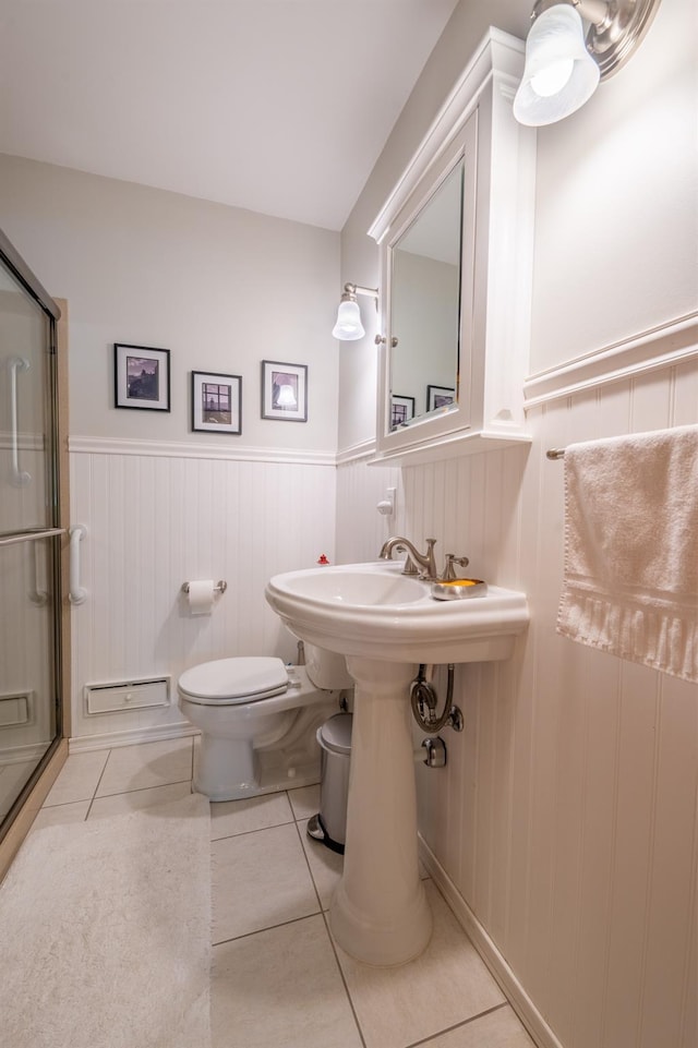 11 Mcintosh Dr, Poughkeepsie, NY 12603 - full bathroom with toilet, a stall shower, a wainscoted wall, tile patterned floors, and baseboard heating
