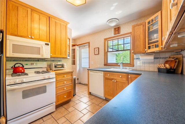 11 Mcintosh Dr, Poughkeepsie, NY 12603 - kitchen featuring a sink, white appliances, tasteful backsplash, under cabinet range hood, and glass insert cabinets