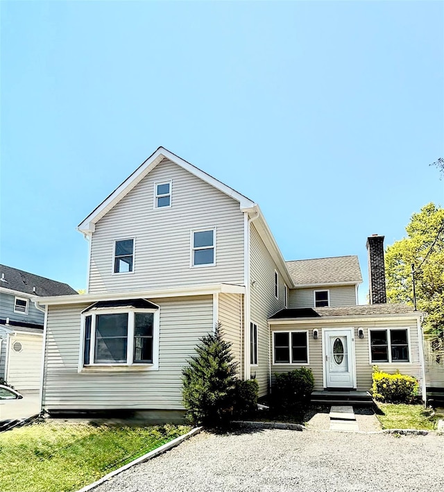 8 Maple St, Glenwood Landing, NY 11547 - traditional home featuring a chimney