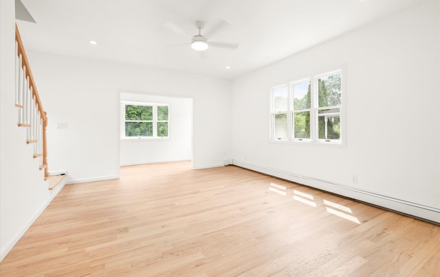 8 Maple St, Glenwood Landing, NY 11547 - spare room featuring stairs, a baseboard heating unit, light wood-style flooring, ceiling fan, and recessed lighting