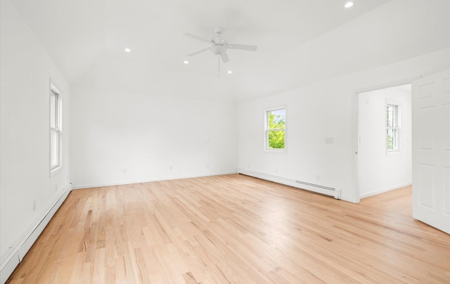 8 Maple St, Glenwood Landing, NY 11547 - spare room with baseboard heating, a baseboard heating unit, light wood finished floors, vaulted ceiling, and a ceiling fan