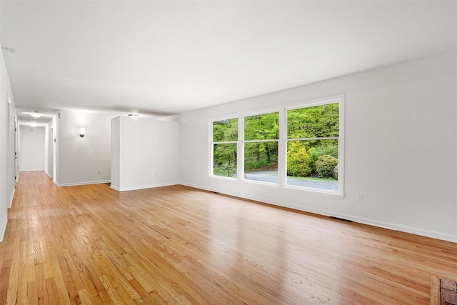 unfurnished living room featuring light wood-style floors and baseboards