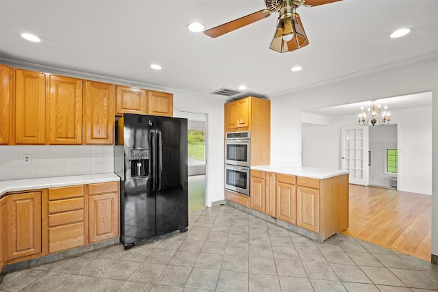 kitchen featuring black refrigerator with ice dispenser, stainless steel double oven, backsplash, a ceiling fan, and recessed lighting