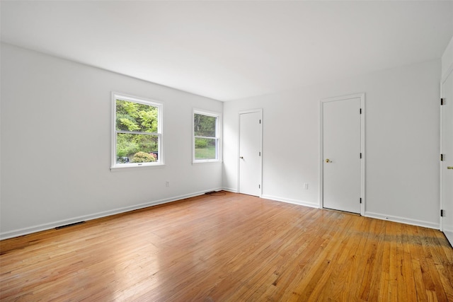 unfurnished room featuring light wood-type flooring and baseboards