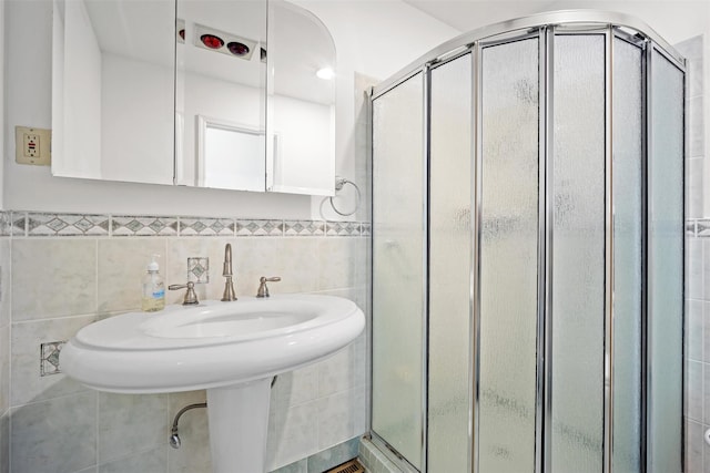 full bath with a stall shower and tile walls