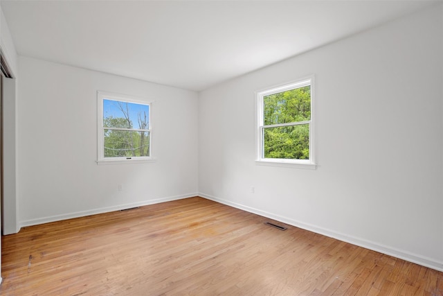 empty room featuring light wood-style floors and baseboards