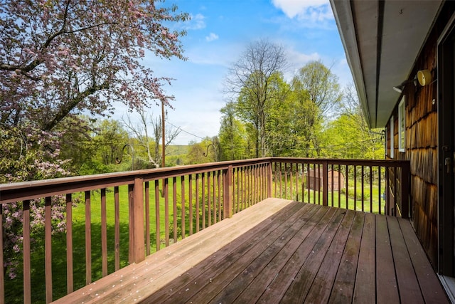 wooden terrace featuring a yard