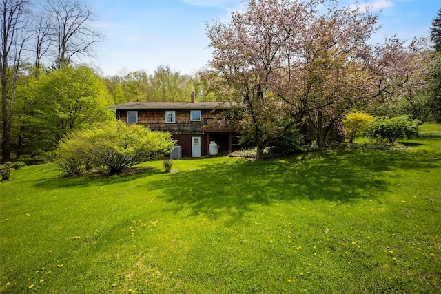 view of grassy yard with a wooden deck