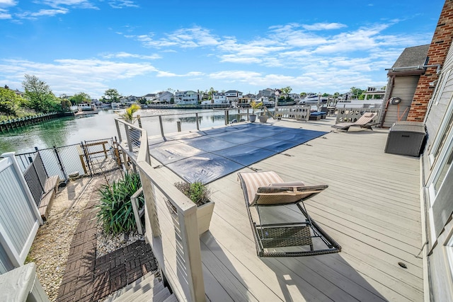 3452 Ocean Ave, Oceanside, NY 11572 - view of swimming pool featuring fence and a deck with water view