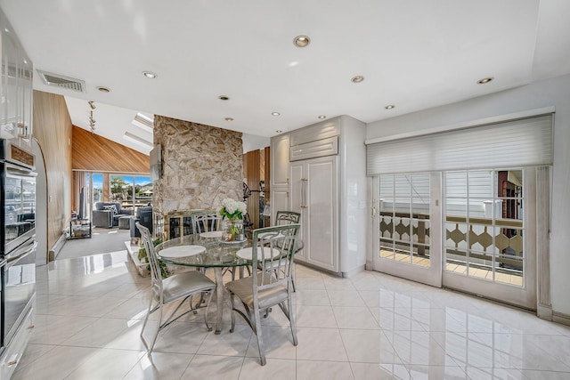3452 Ocean Ave, Oceanside, NY 11572 - dining area featuring light tile patterned flooring, recessed lighting, a stone fireplace, and wooden walls