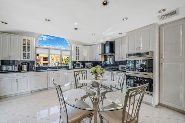 3452 Ocean Ave, Oceanside, NY 11572 - dining space with lofted ceiling, recessed lighting, and light tile patterned floors