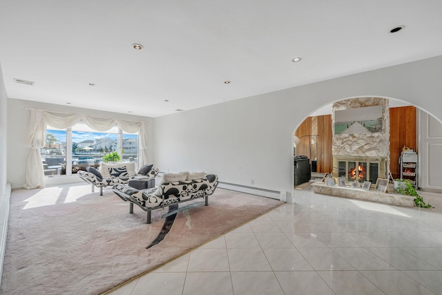 3452 Ocean Ave, Oceanside, NY 11572 - living room with a baseboard radiator, arched walkways, a fireplace, tile patterned floors, and recessed lighting