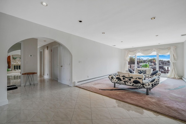 3452 Ocean Ave, Oceanside, NY 11572 - living room featuring arched walkways, a baseboard heating unit, light tile patterned floors, baseboards, and recessed lighting
