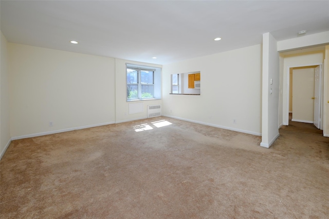 4 Sadore Ln Unit 3M, Yonkers, NY 10710 - spare room featuring light carpet, radiator, recessed lighting, baseboards, and a smoke detector