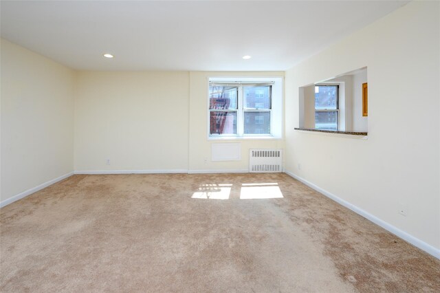 4 Sadore Ln Unit 3M, Yonkers, NY 10710 - spare room with radiator heating unit, carpet flooring, baseboards, and recessed lighting