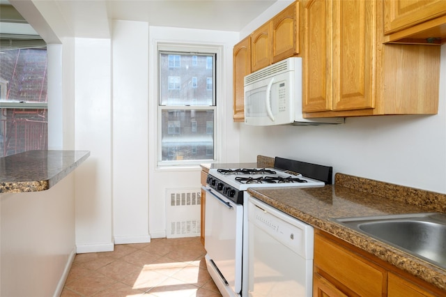 4 Sadore Ln Unit 3M, Yonkers, NY 10710 - kitchen featuring white appliances, radiator heating unit, dark countertops, baseboards, and light tile patterned floors