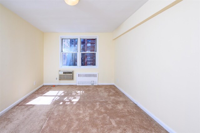4 Sadore Ln Unit 3M, Yonkers, NY 10710 - empty room featuring radiator heating unit, a wall mounted air conditioner, carpet, and baseboards