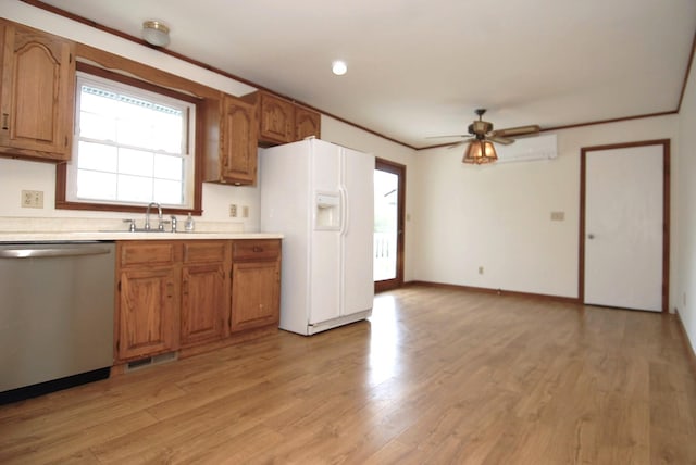 10 Aspinwall Rd, Red Hook, NY 12571 - kitchen with a healthy amount of sunlight, stainless steel dishwasher, a sink, light countertops, and white fridge with ice dispenser