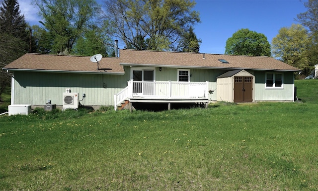10 Aspinwall Rd, Red Hook, NY 12571 - back of house with a lawn, a storage shed, ac unit, a wooden deck, and an outdoor structure