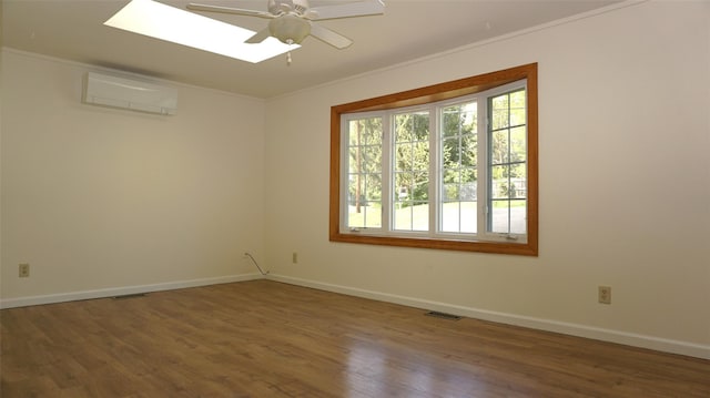 10 Aspinwall Rd, Red Hook, NY 12571 - spare room featuring a skylight, a wall mounted AC, wood finished floors, baseboards, and ornamental molding