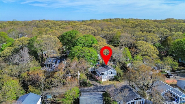 bird's eye view with a wooded view