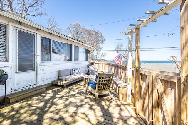 wooden terrace with fence and outdoor lounge area