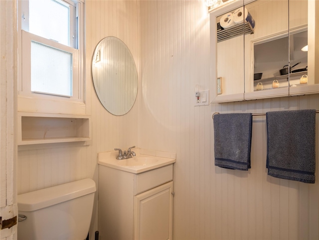 half bath featuring toilet and vanity