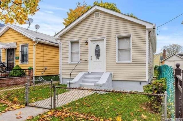 view of front facade featuring a gate, fence private yard, and entry steps
