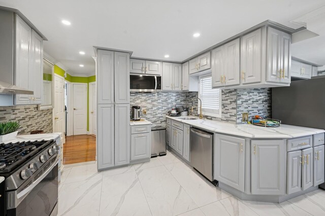 kitchen with a sink, gray cabinetry, and stainless steel appliances