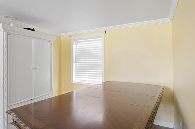 unfurnished bedroom featuring ornamental molding